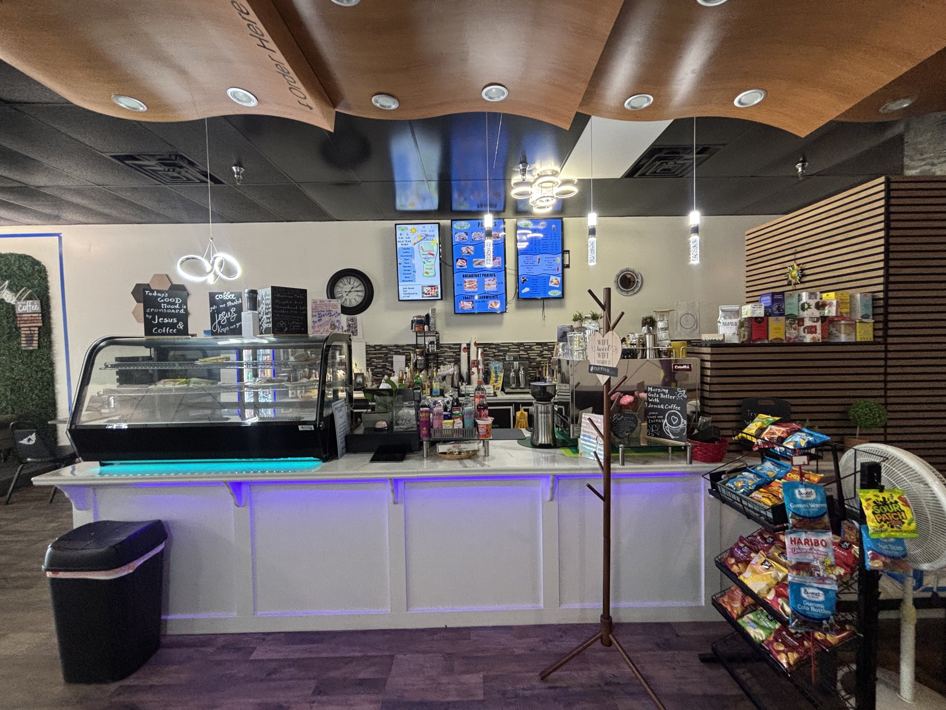 The front counter, pastry case, and menu boards at Panini Coffee House
